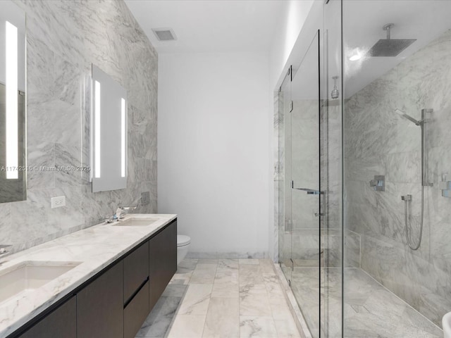 bathroom featuring an enclosed shower, vanity, and toilet