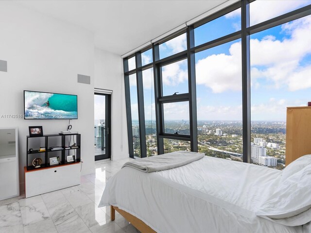 1451 Brickell Ave Unit 5101, Miami, FL 33131 - bedroom featuring a wall of windows, multiple windows, marble finish floors, and a city view