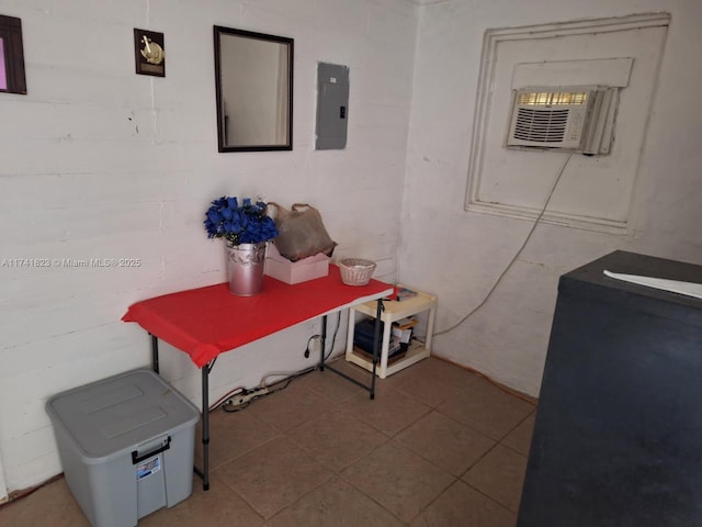 hall with tile patterned flooring and concrete block wall