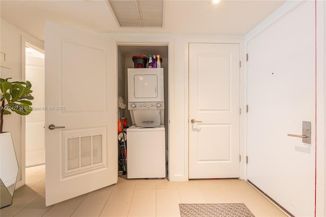 laundry room featuring stacked washer / drying machine