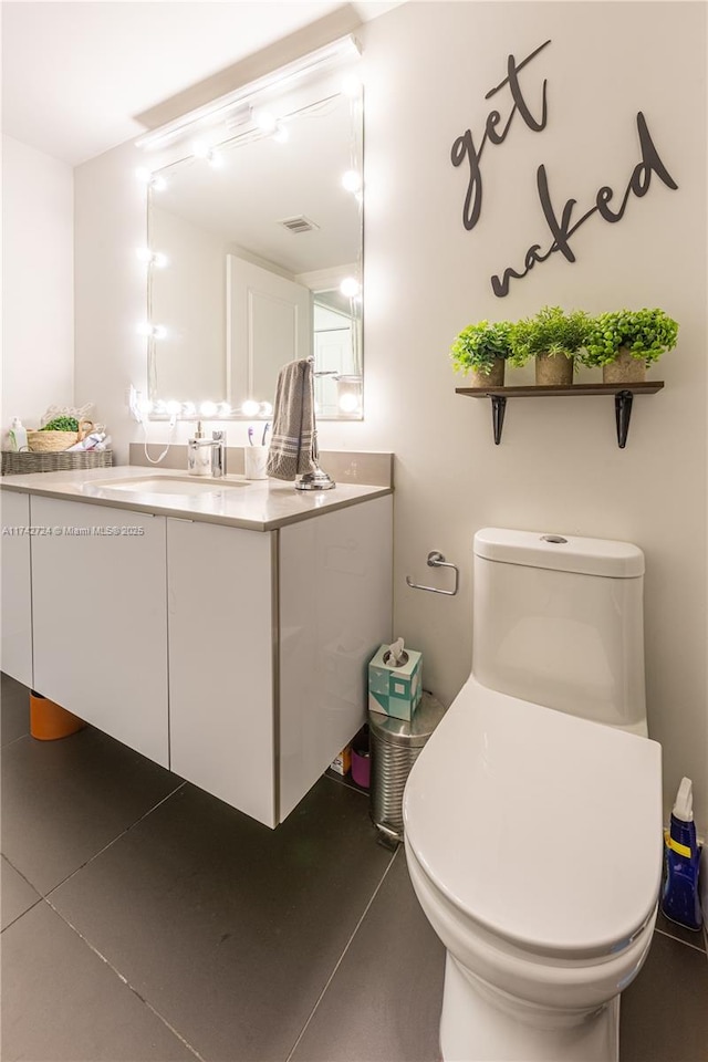 bathroom featuring vanity and toilet