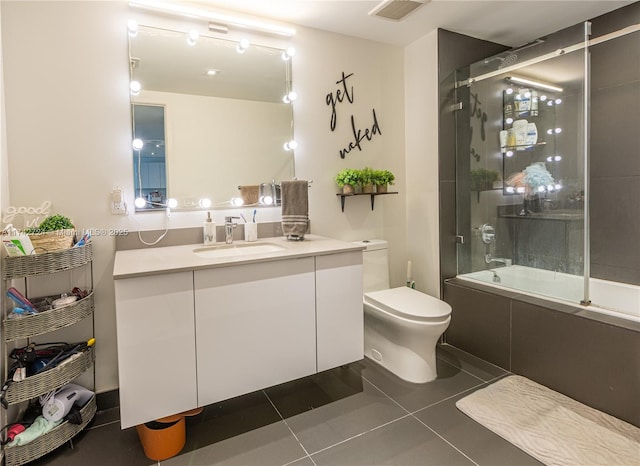 full bathroom with vanity, toilet, tile patterned flooring, and combined bath / shower with glass door