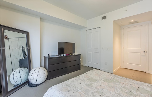 tiled bedroom with a closet