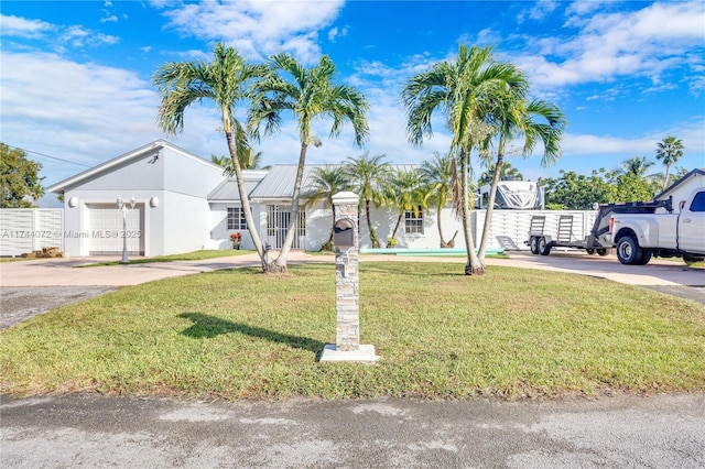 view of front of home featuring a garage and a front yard