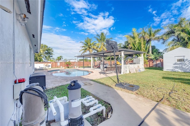 view of patio / terrace with a fenced in pool, a gazebo, and a storage shed