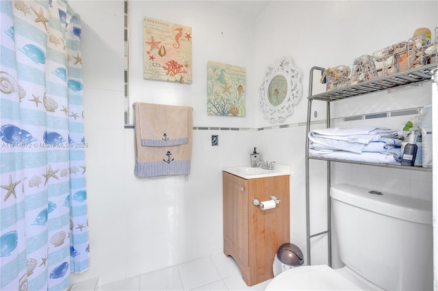 bathroom with a shower with curtain, tile patterned floors, vanity, and toilet