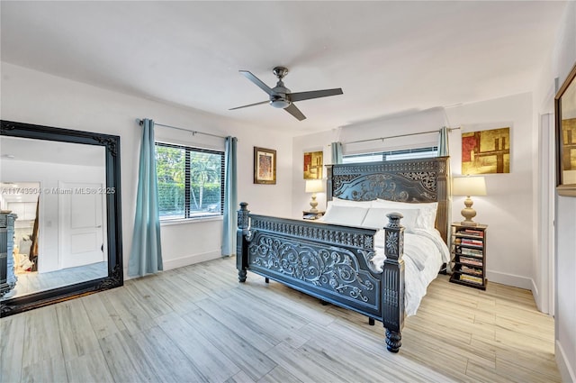 bedroom with light hardwood / wood-style floors and ceiling fan