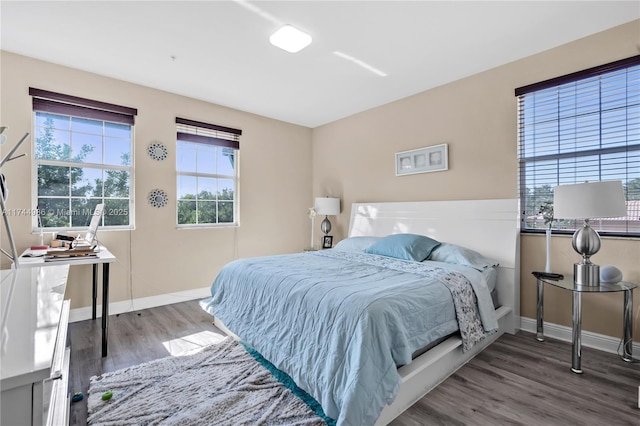 bedroom featuring baseboards and wood finished floors