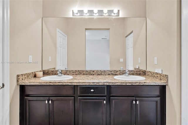 bathroom with a sink and double vanity