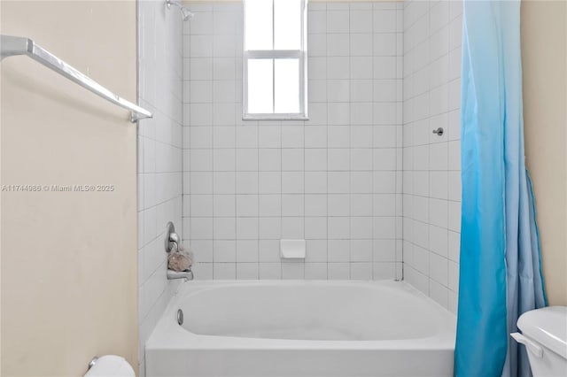 bathroom with shower / bathtub combination with curtain and toilet