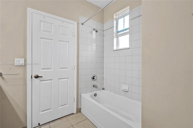 bathroom featuring tiled shower / bath combo and tile patterned floors