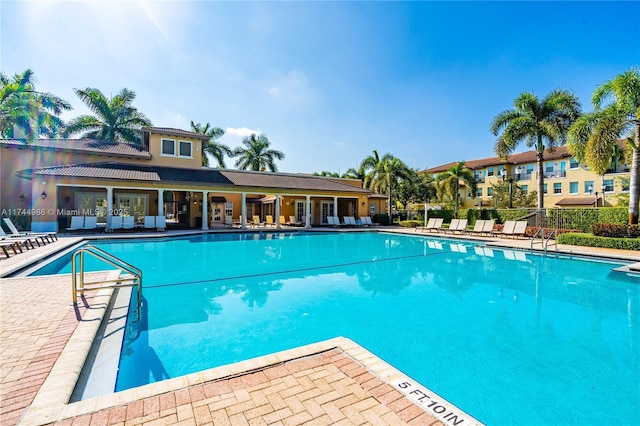 community pool featuring a patio area and fence