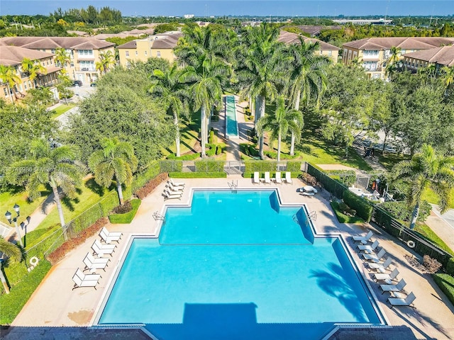 view of swimming pool featuring fence and a patio