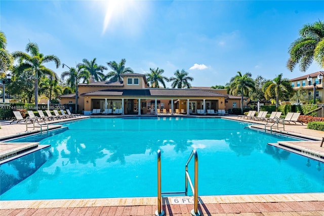 community pool featuring a patio area and fence