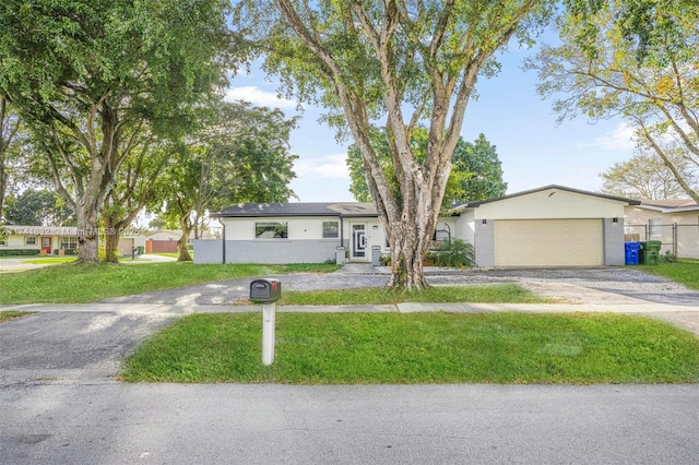 single story home with a garage and a front lawn