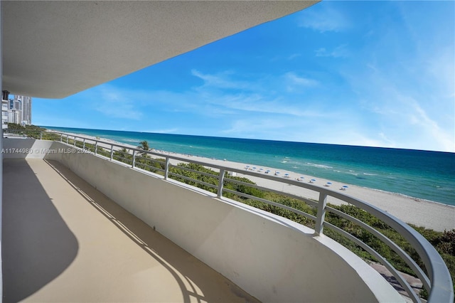 balcony featuring a water view and a view of the beach