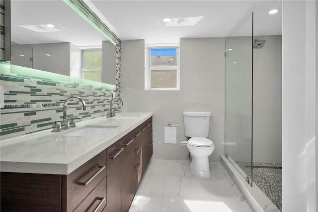 bathroom with vanity, tasteful backsplash, a shower with shower door, and toilet