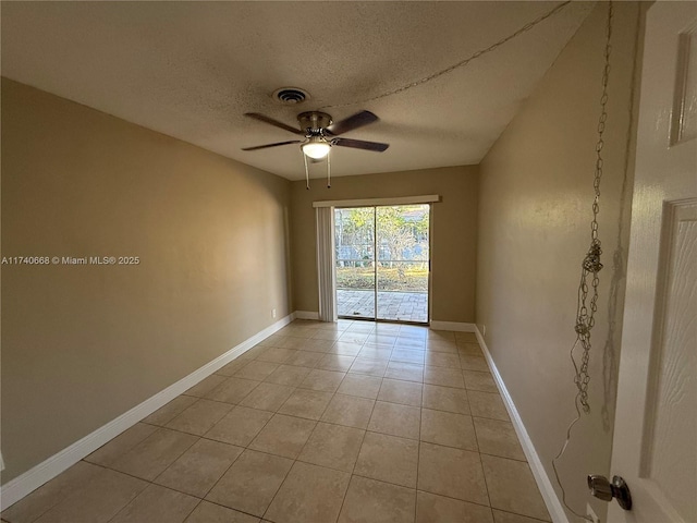 tiled spare room featuring ceiling fan and a textured ceiling