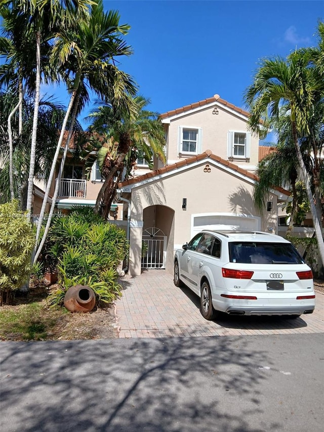 mediterranean / spanish home with a garage