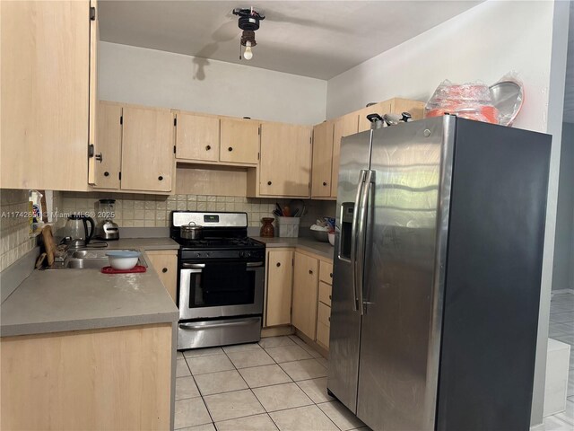 1445 NE 136th St, North Miami, FL 33161 - kitchen with stainless steel appliances, light brown cabinetry, and tasteful backsplash