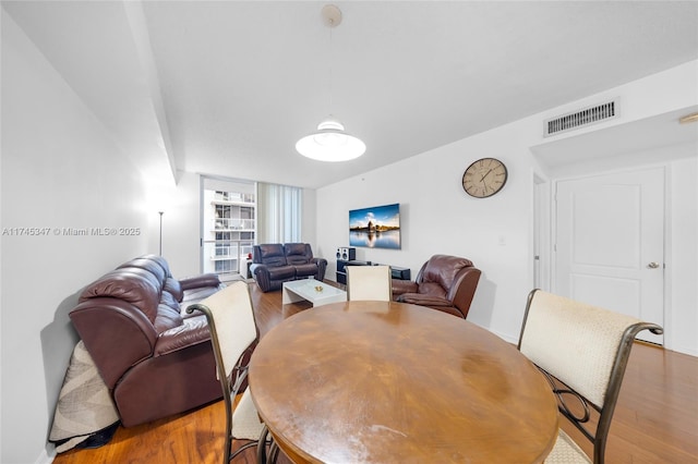 dining room featuring hardwood / wood-style flooring and expansive windows