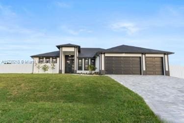 view of front facade with a garage and a front lawn