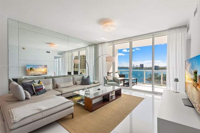 tiled living room featuring floor to ceiling windows