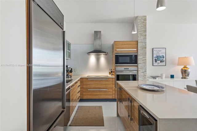 kitchen featuring decorative light fixtures, range hood, wine cooler, a center island, and black appliances