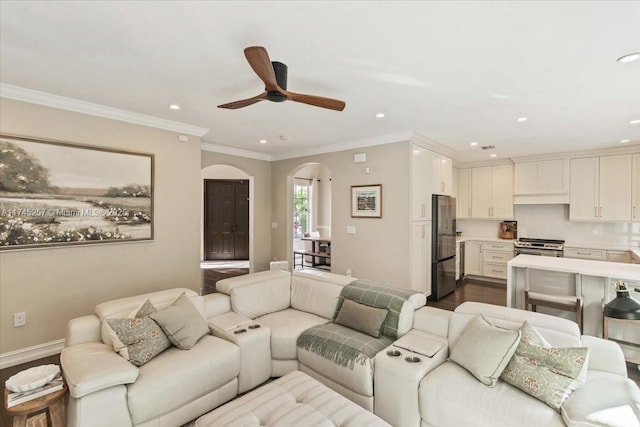 living room featuring hardwood / wood-style flooring, ceiling fan, and ornamental molding