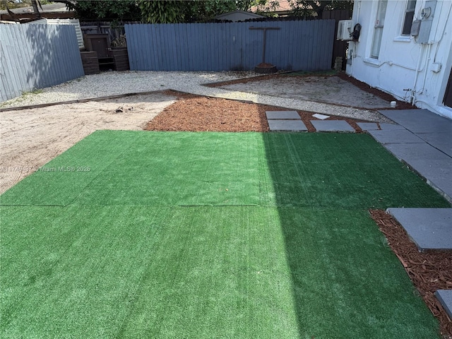 view of yard with fence and a patio
