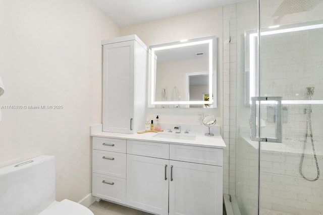 bathroom with vanity, toilet, and walk in shower