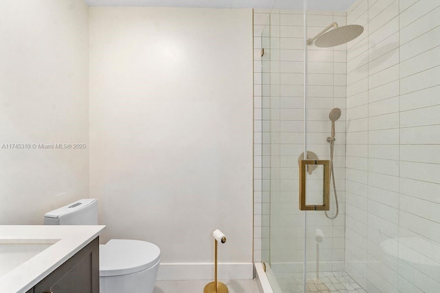 bathroom featuring vanity, toilet, and a shower with door