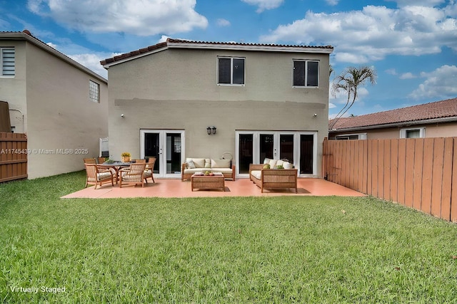 back of property featuring french doors, an outdoor living space, a lawn, and a patio area