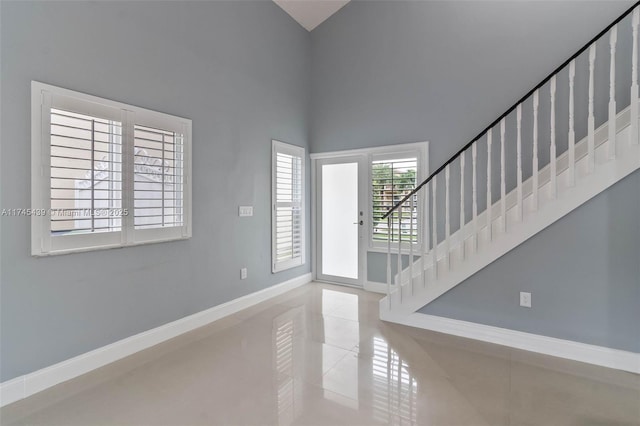 tiled foyer entrance featuring a high ceiling