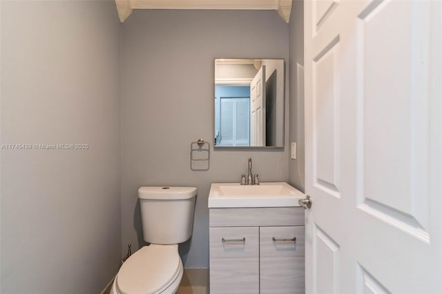 bathroom featuring toilet and vanity