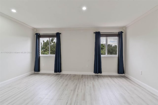 empty room featuring light hardwood / wood-style flooring and crown molding