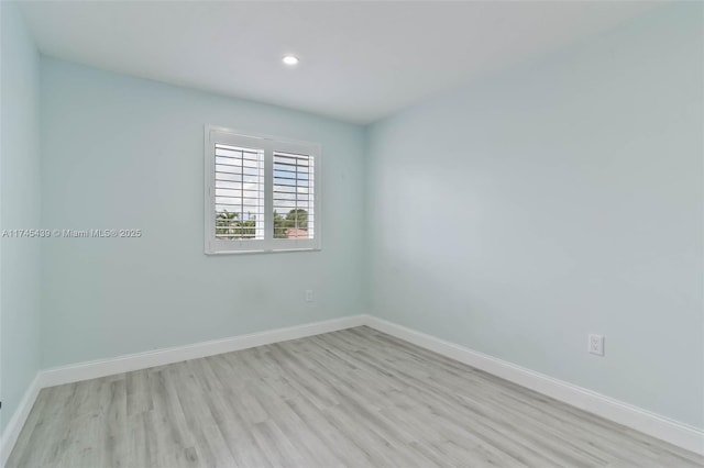 unfurnished room with light wood-type flooring