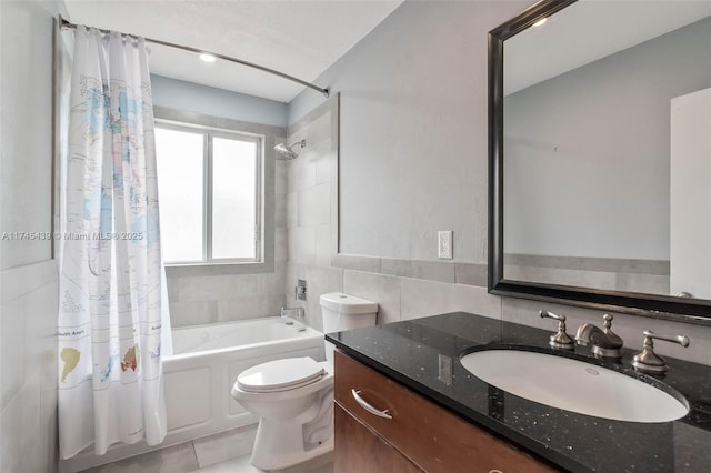 full bathroom with tile walls, vanity, toilet, and shower / bath combo