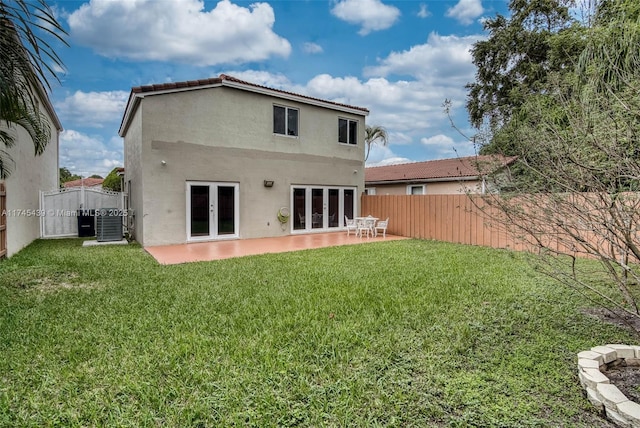 back of property featuring a patio area, a yard, and central air condition unit