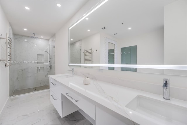 bathroom featuring vanity and an enclosed shower