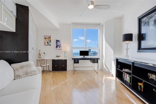 living room featuring ceiling fan and light wood-type flooring