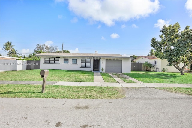 view of front of home with a garage and a front yard