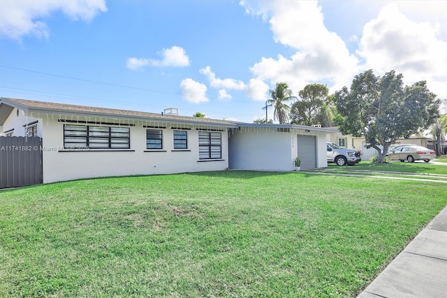 ranch-style home featuring a garage and a front lawn