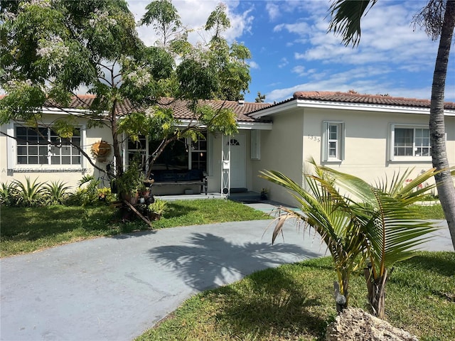 view of front of home featuring a tile roof and stucco siding