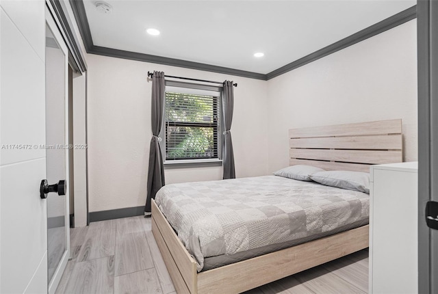 bedroom featuring crown molding and light hardwood / wood-style floors