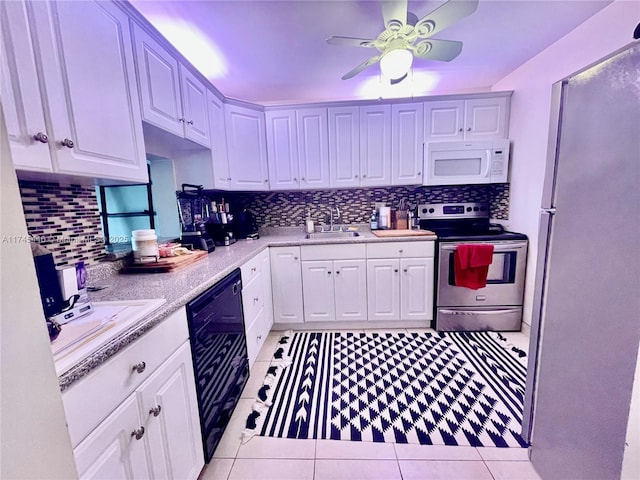 kitchen with stainless steel electric stove, refrigerator, black dishwasher, sink, and white cabinets