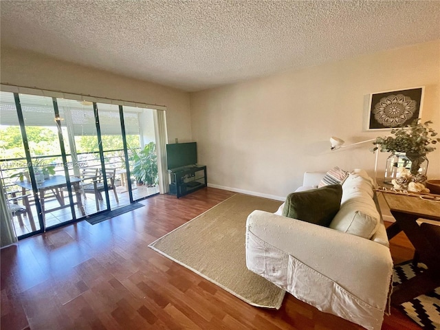 living room with hardwood / wood-style flooring and a textured ceiling