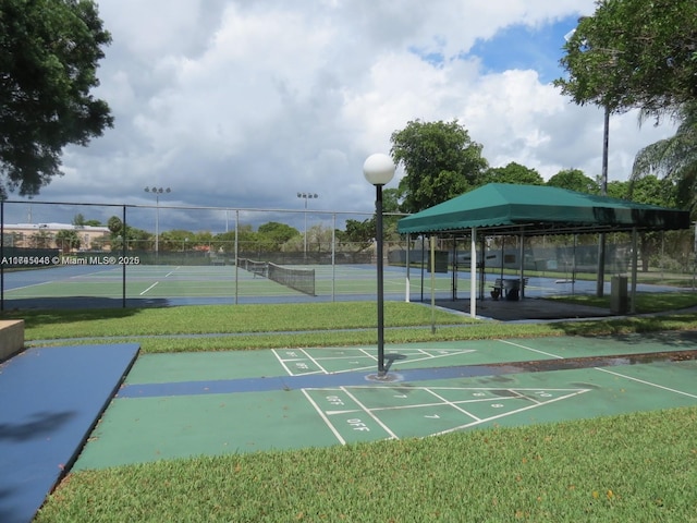 view of property's community with tennis court