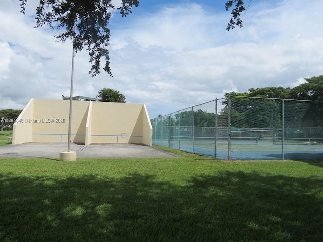 view of sport court featuring a yard