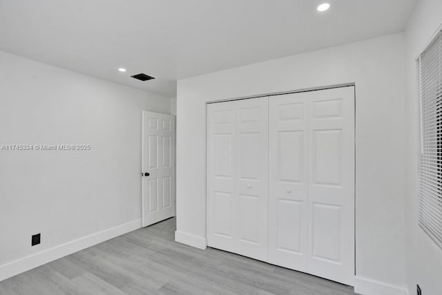 1628 NE 7th Ave, Fort Lauderdale, FL 33305 - unfurnished bedroom with recessed lighting, a closet, light wood-style flooring, and baseboards